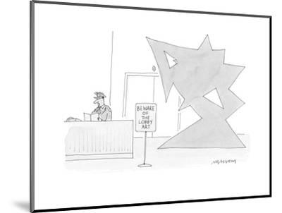 400x302 security guard in an office building sits near a sign saying