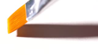 320x180 Drawing With A Square Paintbrush On White Paper Close Up. Stock