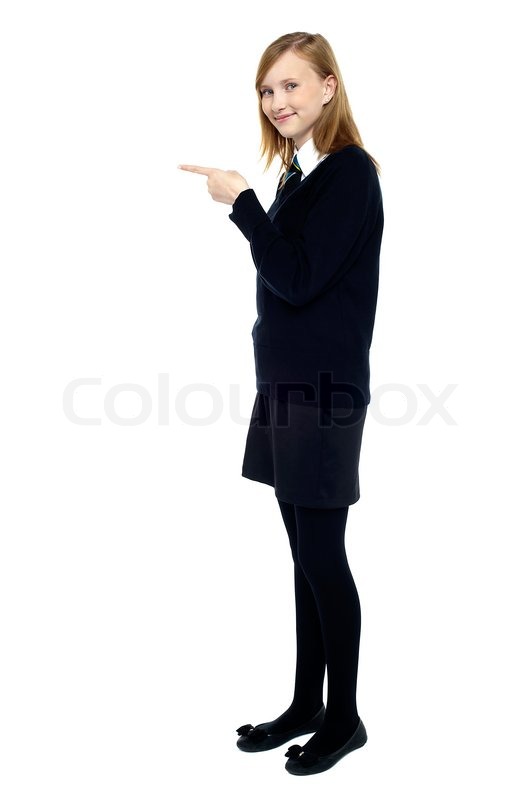 532x800 Student Standing Sideways And Pointing Forward Stock Photo