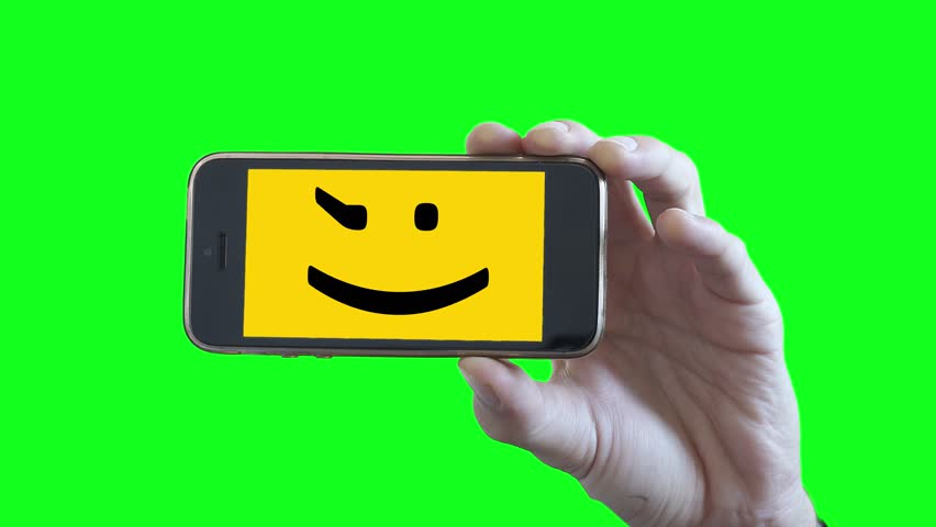 852x480 Smiley Face Smartphone On Green Screen Background. Male Hand
