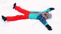 240x134 Video Young Boy Makes A Snow Angel. Overhead Shot. ~
